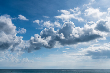 Fototapeta na wymiar The tropical sea under the blue sky and clouds