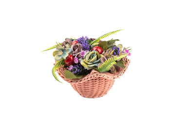 Fototapeta na wymiar Flower arrangement of artificial flowers in a plastic wicker basket isolated on a white background.