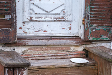 "Please Do Not Sit on Steps" Sign on Old, Worn Steps 