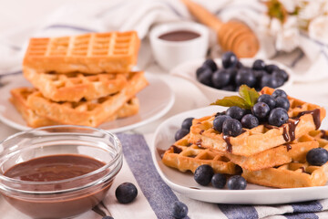 Waffles with blueberries and chocolate cream. 