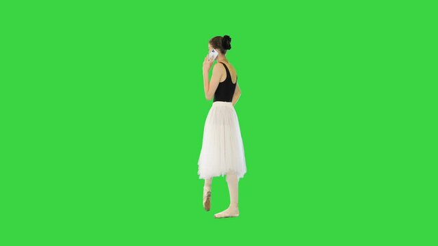 Young ballerina making a phone call on a Green Screen, Chroma Key.
