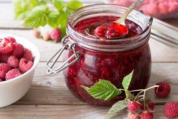 Raspberry jam on wooden table