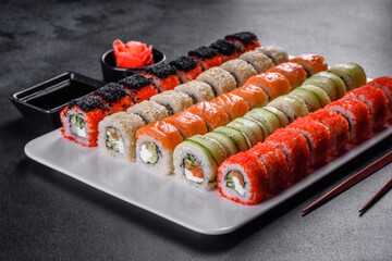 Delicious fresh rolls in various sets. Japanese food with avocado, shrimp, crab and salmon