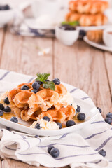 Waffles with blueberries and chocolate cream. 
