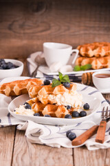 Waffles with blueberries and chocolate cream. 