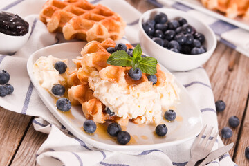 Waffles with blueberries and chocolate cream. 