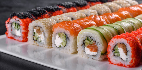 Delicious fresh rolls in various sets. Japanese food with avocado, shrimp, crab and salmon