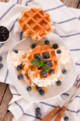 Waffles with blueberries and chocolate cream. 