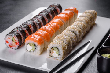 Delicious fresh rolls in various sets. Japanese food with avocado, shrimp, crab and salmon