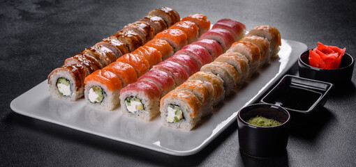 Delicious fresh rolls in various sets. Japanese food with avocado, shrimp, crab and salmon