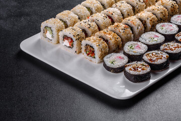 Delicious fresh rolls in various sets. Japanese food with avocado, shrimp, crab and salmon