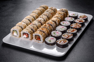 Delicious fresh rolls in various sets. Japanese food with avocado, shrimp, crab and salmon