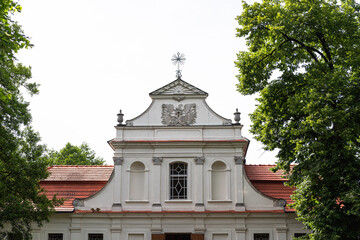 Fototapeta na wymiar Facade of baroque Church of St. John of Nepomuk on the water in Zwierzyniec, Lubelskie, Poland
