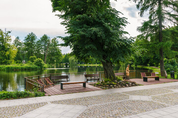 Promenade in Zwierzyniec, Lubelskie, Poland - with view on a big pond and park in city center