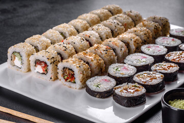 Delicious fresh rolls in various sets. Japanese food with avocado, shrimp, crab and salmon