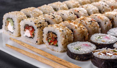 Delicious fresh rolls in various sets. Japanese food with avocado, shrimp, crab and salmon