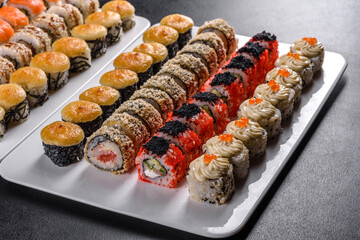 Delicious fresh rolls in various sets. Japanese food with avocado, shrimp, crab and salmon