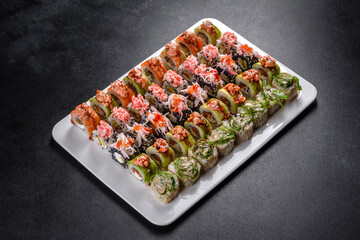 Delicious fresh rolls in various sets. Japanese food with avocado, shrimp, crab and salmon