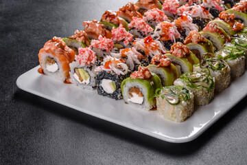 Delicious fresh rolls in various sets. Japanese food with avocado, shrimp, crab and salmon