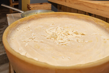 Huge ball of grana padano cheese in a typical Italian restaurant