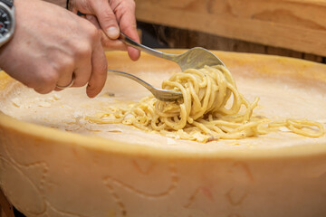 Traditional Italian spaghetti soaked inside a grana padano cheese