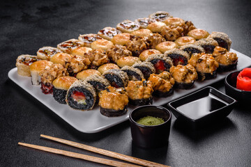 Delicious fresh rolls in various sets. Japanese food with avocado, shrimp, crab and salmon
