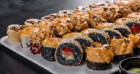 Delicious fresh rolls in various sets. Japanese food with avocado, shrimp, crab and salmon