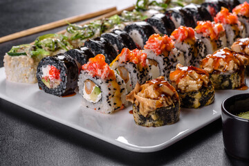 Delicious fresh rolls in various sets. Japanese food with avocado, shrimp, crab and salmon