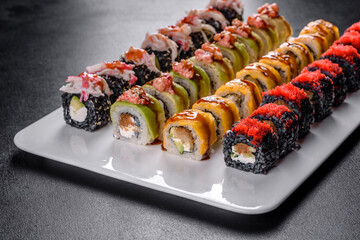 Delicious fresh rolls in various sets. Japanese food with avocado, shrimp, crab and salmon