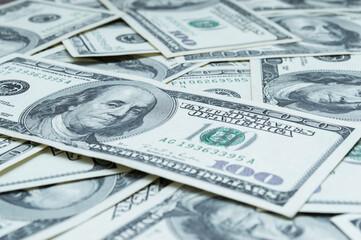 One hundred US dollars banknotes. Cash one hundred dollar bills, 100 dollars, Benjamin Franklin portrait, american currency exchange finance. Pile of hundred US dollars