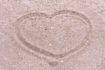 Fototapeta na wymiar a heart on the sand on the seashore. close-up