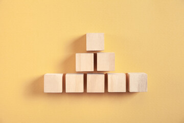 Wooden cubes on yellow background.