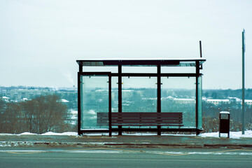 Empty Bus Stop in winter city. empty stop in the cold snowy weather. copy space. empty street....
