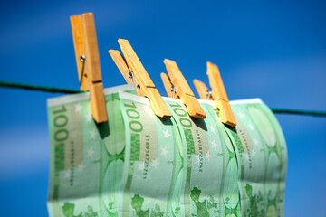 100 euro banknotes on a clothesline. Money laundering theme.