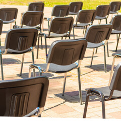 Chairs stand in rows keeping their distance.