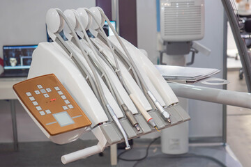 Dental unit with upper supply of instruments. White dental unit. Touch panel for adjustment on it. Dental equipment. Equipment for the repair of teeth. Concept - sale of dentist equipment