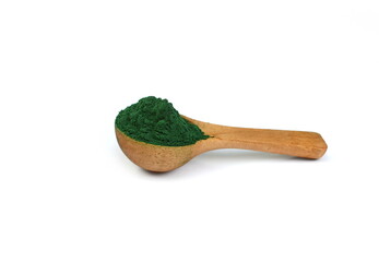 Organic spirulina algae powder in a wooden spoon  isolated on white. Organic spirulina powder. Spirulina is a superfood used as a food supplement source of vitamin protein and beta carotene. - obrazy, fototapety, plakaty