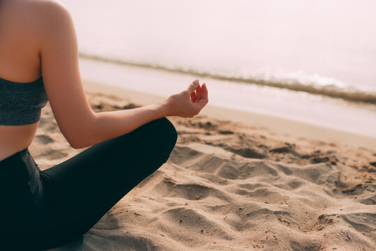Photo of sport woman yoga beach, practicing morning meditation in nature at the beach