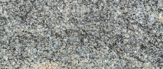 Texture of the rocky surface. Granite texture as nature background. Natural gray granite with a grainy pattern