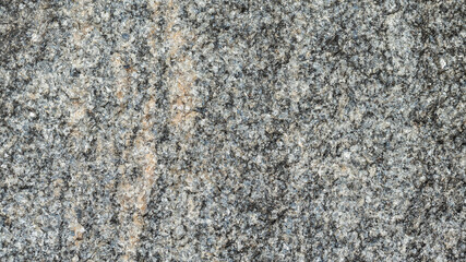 Texture of the rocky surface. Granite texture as nature background. Natural gray granite with a grainy pattern