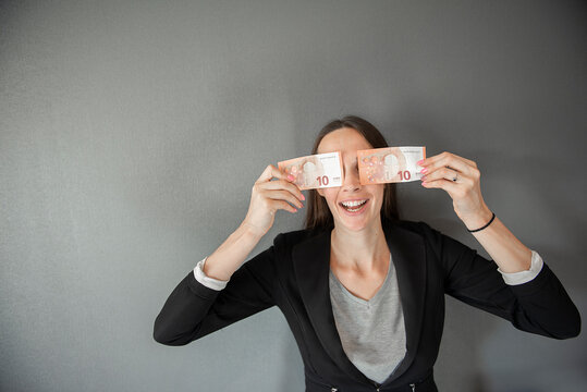 happy female holding euro money, young woman covering her face eyes with 10 euro bills note