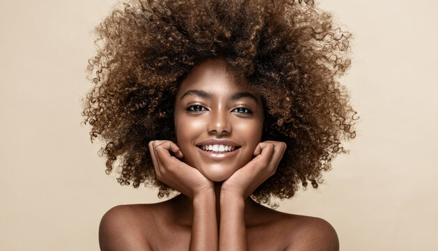 Beauty portrait of african american woman with clean healthy skin on beige background. Smiling dreamy beautiful afro girl.Curly black hair