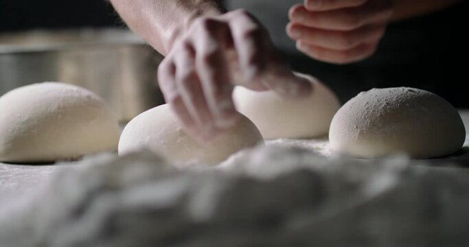 Close up shot of bakery worker carefuly forming loafs of bread. Baker making dough, using natural ingredients. food and drink 4k footage