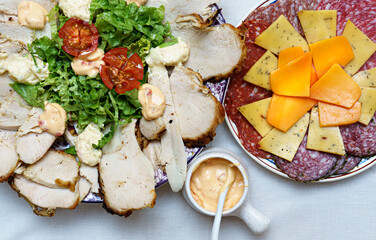 table cold cuts cheeses sliced chicken breast garnishes Top view
