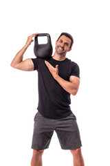 Athlete is a European man, holding a weight on shoulder, pointing with finger, advertising a healthy sports lifestyle. On a white background.