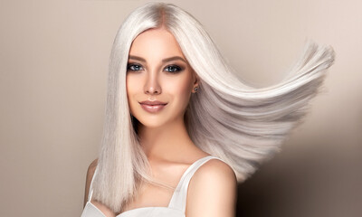 Beautiful girl with hair coloring in ultra blond. Stylish hairstyle done in a beauty salon. Fashion, cosmetics and makeup - obrazy, fototapety, plakaty