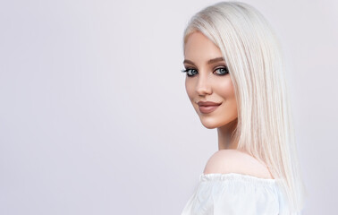 Beautiful girl with hair coloring in ultra blond. Stylish hairstyle done in a beauty salon....