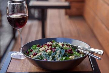 green salad served with olive oil and a glass of red wine 