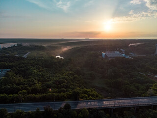 Aerial sunrise morning skyscape. Multistory buildings and greenery with fog at dawn in nice pastel light. View on Sokilnyky with Derevianka st bridge across Sarzhyn Yar in Kharkiv city.