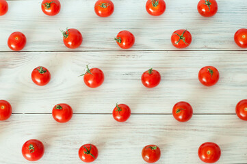 Naklejka na ściany i meble fresh cherry tomatoes scattered on a wooden deck. High quality photo